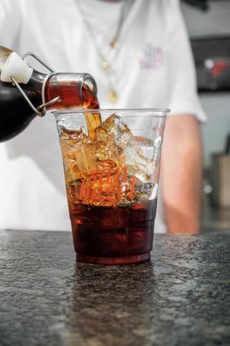 a drink is being being poured into a glass at District Polanco by Lumina in Mexico City