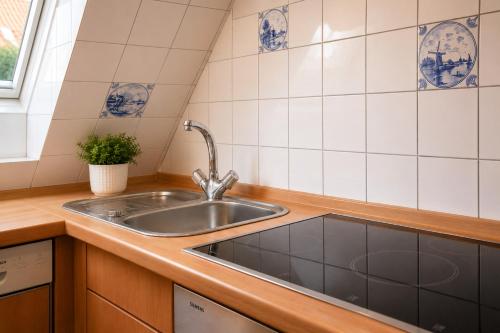 a kitchen with a sink and a counter top at Glaeßer Appartements in Burg auf Fehmarn