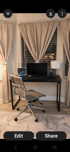 an office with a desk with a computer and a chair at The Serene Uptown Flat in Charlotte