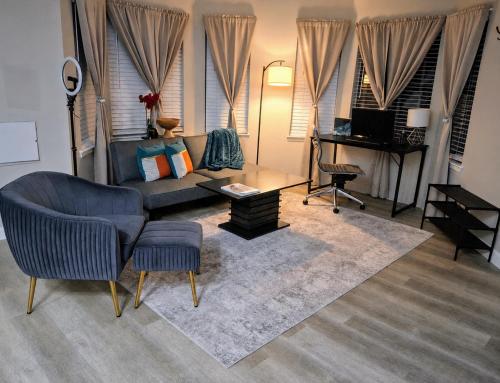 a living room with a couch and a table at The Serene Uptown Flat in Charlotte