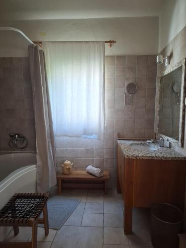 a bathroom with a tub and a sink and a bath tub at Adriatic Lifestyle Apartment in Stari Grad
