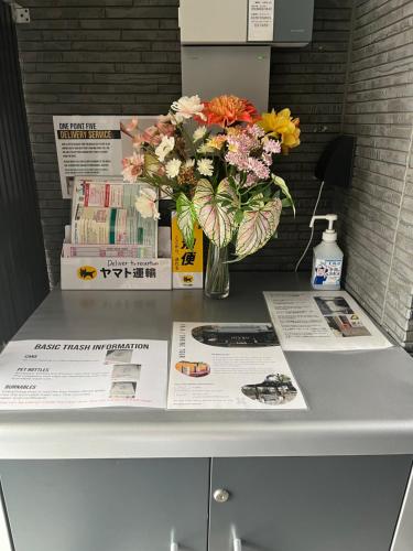 a vase of flowers sitting on top of a table at One Point Five in Tokyo