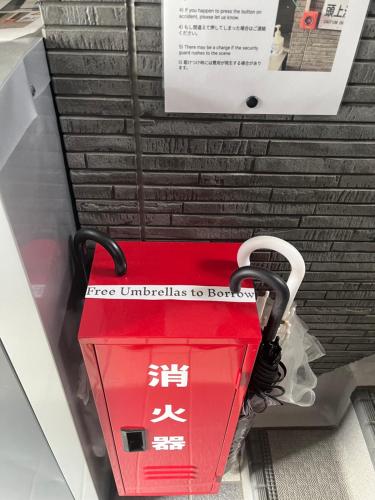 a red box in a store with writing on it at One Point Five in Tokyo