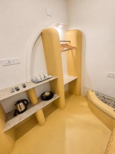 a room with two shelves and a bed in it at Mayura sea view in Malpe