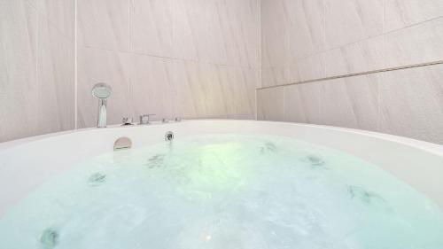 a bath tub in a room with at Gapyeong Shiny Pension in Gapyeong