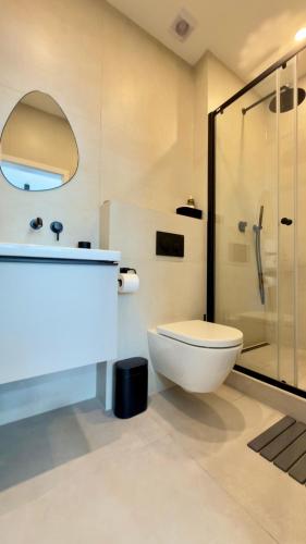 a bathroom with a toilet and a glass shower at Apartmán Vita Smart in Trenčín