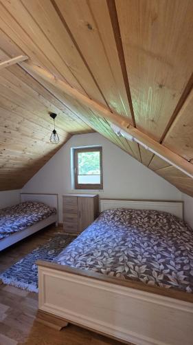a bedroom with two beds in a attic at Domki nad potokiem in Stary Sącz