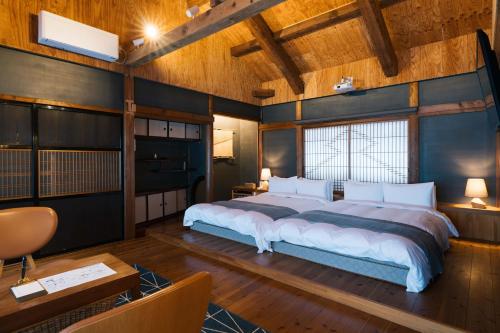 a bedroom with a large bed in a room at CAFE & BB guri in Ine