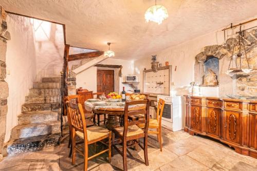 a kitchen with a table and chairs in a room at Luin Country House near Štanjel - Happy Rentals in Štanjel