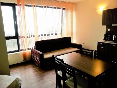 a living room with a couch and a table at Apartments Yalta in Golden Sands
