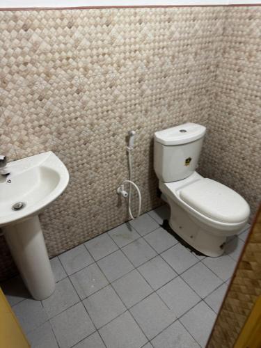a bathroom with a toilet and a sink at Honey guest Batticaloa in Batticaloa