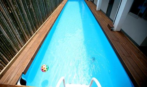 a swimming pool with a ball in the water at Statehouse pension Incheon in Incheon