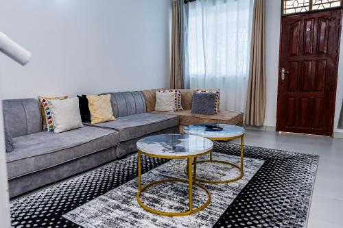 a living room with a couch and two tables at Serena Road Villa C in Mombasa