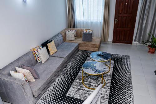 a living room with a couch and a table at Serena Road Villa C in Mombasa