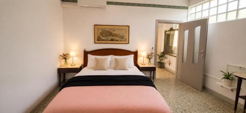 a bedroom with a large bed with two night stands at Iris Peaceful Apartment near Lake Como and Lugano in Lanzo dʼIntelvi