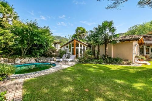 a backyard with a pool and a house at Villa Tre Pini Garden Escape in Lugano