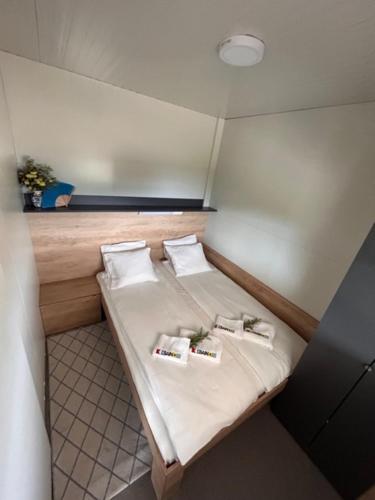 a small room with a bed with three pillows at Beach house Sofia in Otok Žut
