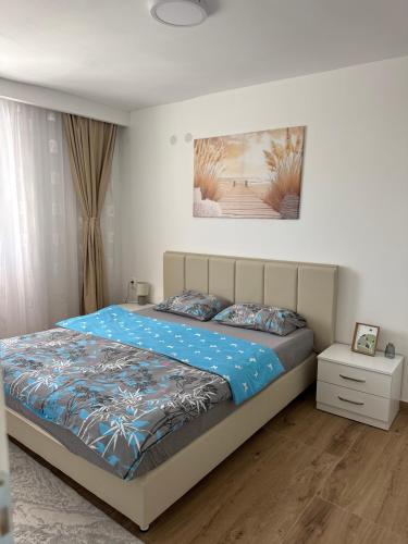 a bedroom with a bed with a blue comforter at Magic Home Cetinje in Cetinje
