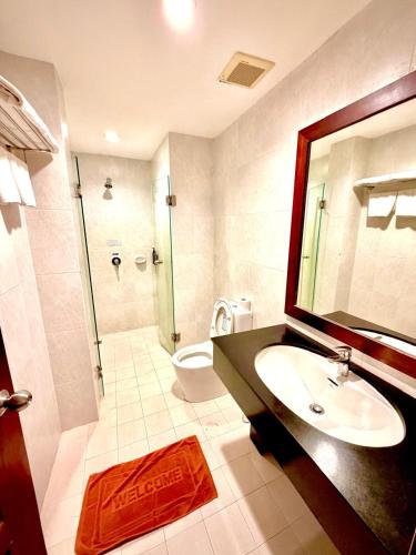 a bathroom with a sink and a shower and a toilet at Sabaidee@Lao Hotel Vientiane in Vientiane