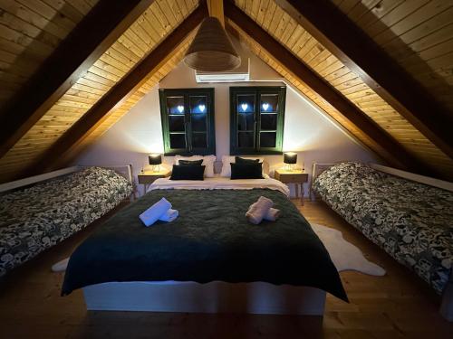 a bedroom with two beds in a attic at Green river cottage in Žažina