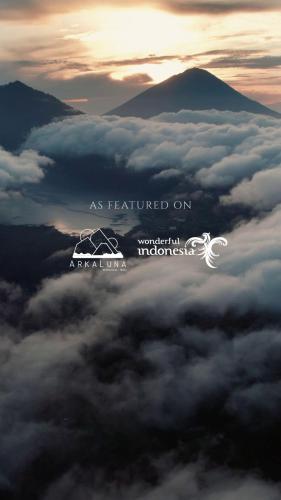 a view of a mountain above a layer of clouds at Arkaluna Resort & Adventure in Kintamani