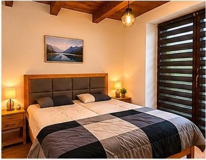 a bedroom with a large bed and a window at Chalet-Širava in Vinné