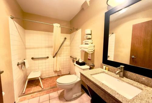 a bathroom with a toilet and a sink at Super 8 by Wyndham Melrose in Melrose