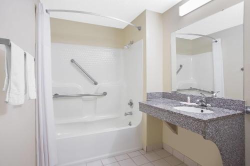 a bathroom with a sink and a shower at Days Inn by Wyndham Dublin GA in Dublin