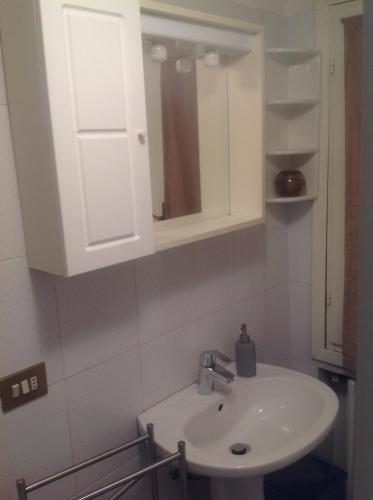 a bathroom with a sink and a white cabinet at SUITE 5 in Reggio Emilia