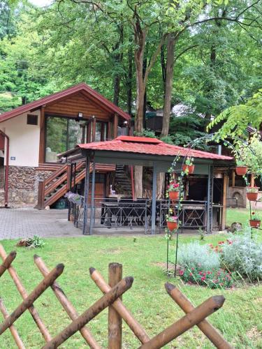 a wooden fence in front of a building at Moravski konak- Moravian Inn in Ovčar Banja
