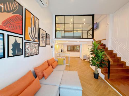 a living room with a couch and a staircase at Sleep Walker Poshtel in Chiang Mai