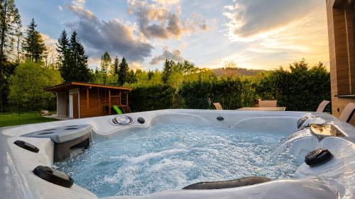 a hot tub in a backyard with a fountain at Villa ZENORIA in Zuberec