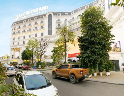 an orange truck parked in front of a building at Duc Huy Grand Hotel and Spa in Lao Cai
