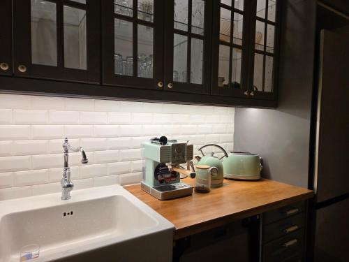 a kitchen counter with a sink and a coffee maker at Villa Denise in Vals-les-Bains