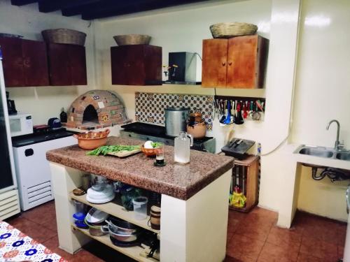 a kitchen with a counter with a stove top oven at Hotel Sicarú in Chapulco