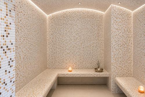 a bathroom with a bench with a candle in it at Crystal Palace Boutique Hotel in Sofia