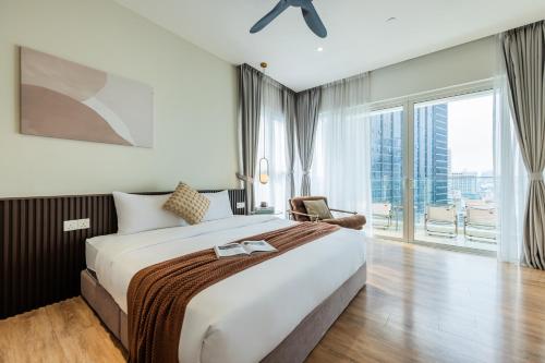 a bedroom with a large bed and a large window at Veone Hotel Kuala Lumpur in Kuala Lumpur
