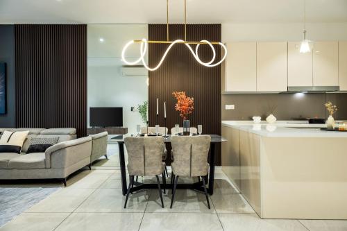 a kitchen and living room with a table and a couch at Veone Hotel Kuala Lumpur in Kuala Lumpur