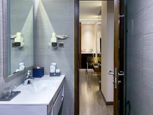 a bathroom with a sink and a mirror at Queen Ann Hotel in Ho Chi Minh City
