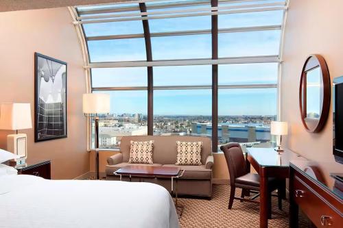 a hotel room with a bed and a large window at Wyndham Denver Tech Center in Greenwood Village