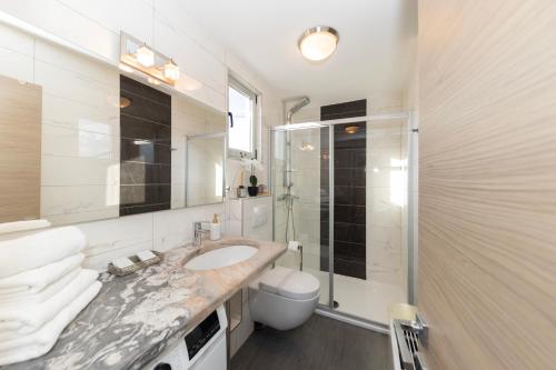 a bathroom with a sink and a shower and a toilet at Villa Kovac in Zadar