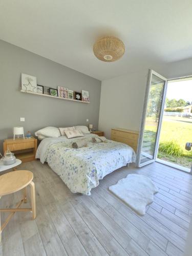 a bedroom with a bed and a large window at Justine's house in Alvignac in Alvignac