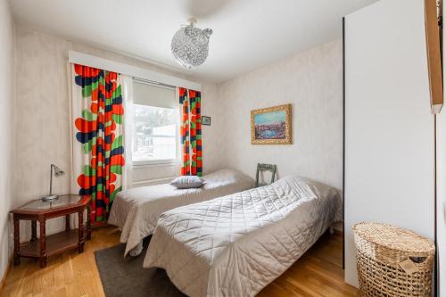 a bedroom with two beds and a window at Pyynpesä ! in Rovaniemi