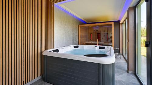 a jacuzzi tub in a room with at Villa Magic by Villas Guide in Jalžabet