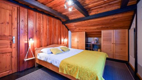 a bedroom with a bed in a wooden cabin at Villa Magic by Villas Guide in Jalžabet