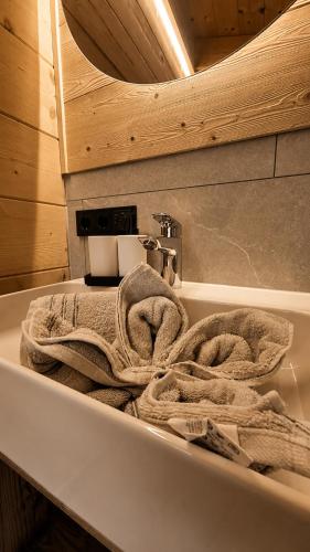 a bathroom with a sink with towels in it at Wieslhütte in Gerlosberg
