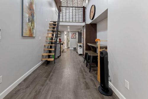 a hallway with a room with a table and a shelf at Bright loft in Wheat Ridge in Wheat Ridge