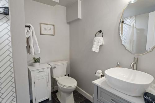 a bathroom with a white toilet and a sink at Bright loft in Wheat Ridge in Wheat Ridge