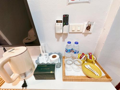 a counter with a coffee maker and a tray with drinks at Aura Hotel Phi Phi in Phi Phi Islands