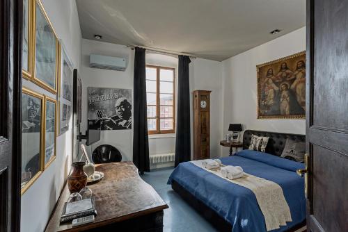 a bedroom with a blue bed and a table at Loft Garibaldi in Chiavari